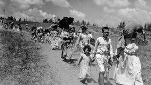 Palestinian refugees leaving a village near Haifa, June 1948.